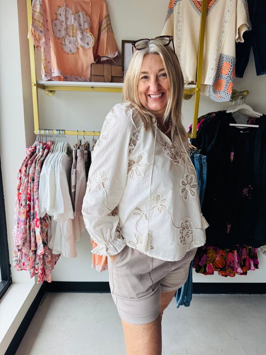 Rain + Rose

Embrace effortless romance with this lightweight bohemian top featuring intricate tonal floral embroidery and charming tassel details. Designed with an airy fit and feminine ruffle cuffs, it’s the perfect versatile piece for transitioning from sun-soaked days to elegant evenings.

Intricate floral embroidery for romantic detail.
Lightweight fabric ensures airy, breathable comfort.
Playful tassel-tie neck adds boho charm.
Elegant ruffle cuffs finish long sleeves.
Versatile design transitions day