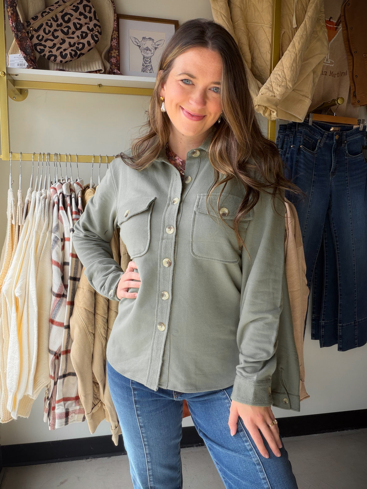 Model wearing a sea spray green French terry shacket with a collar, button front and chest flap pockets.