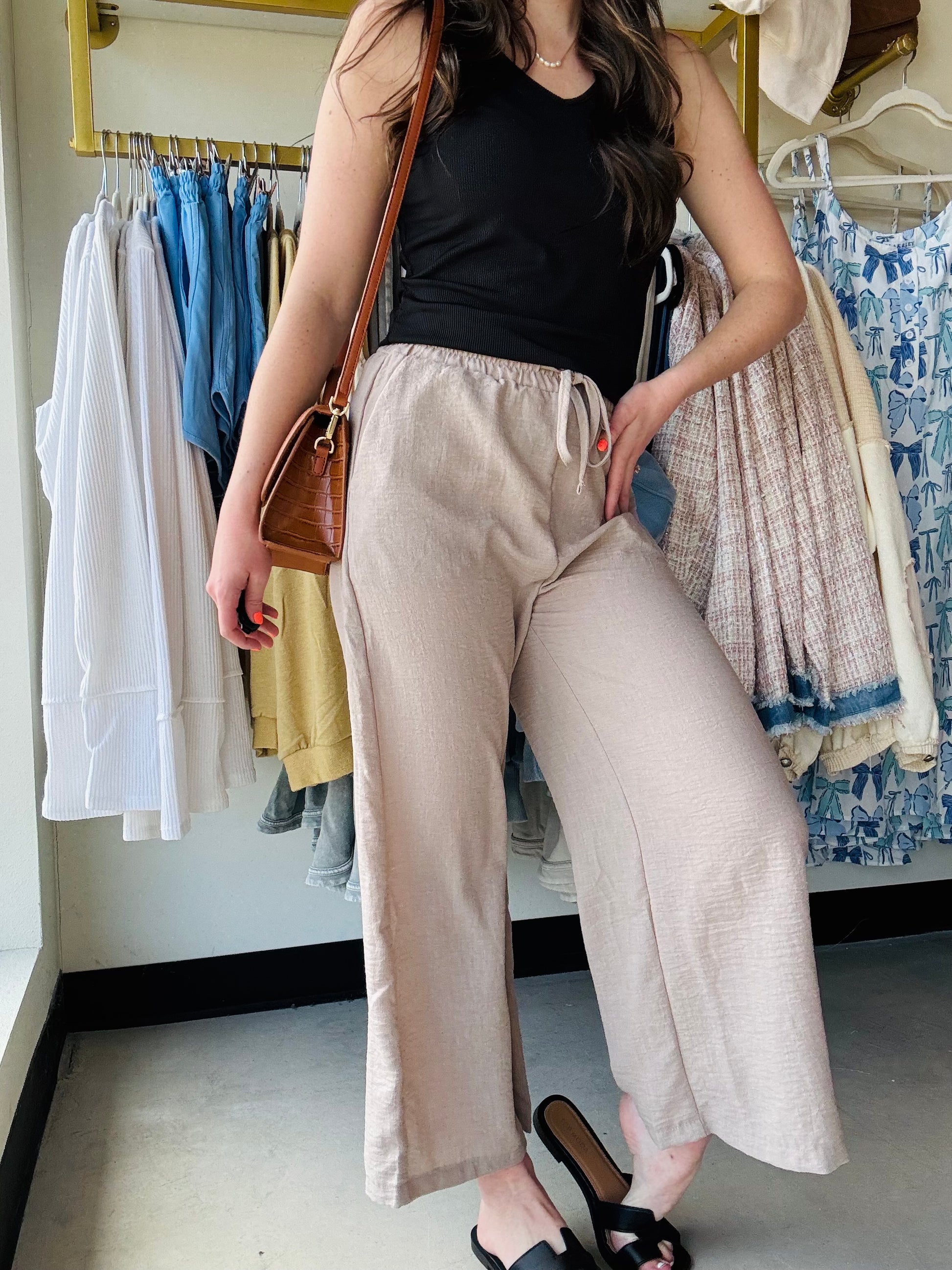 These Mocha Woven Wide Leg Pants are a stylish and comfortable addition to any wardrobe. Made with high quality woven crepe fabric, they feature an elastic band waist and drawstring waistband for a perfect fit. The side pockets add convenience and functionality to these cropped pants. Perfect for any casual or dressy occasion!