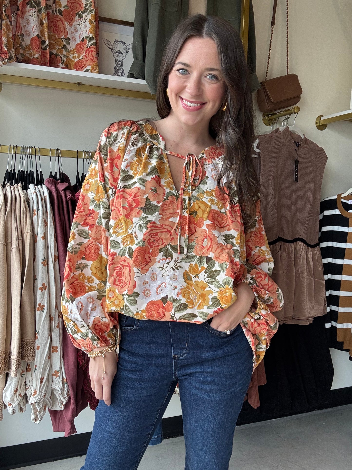 Bibi

This orange floral blouse features exaggerated balloon sleeves and a front tie detail, combining bold design with feminine elegance. Its lightweight fabric ensures comfort and breathability, while the vibrant print adds a fresh, stylish touch to any outfit. Ideal for elevating both casual and dressier looks with a confident, expert flair.