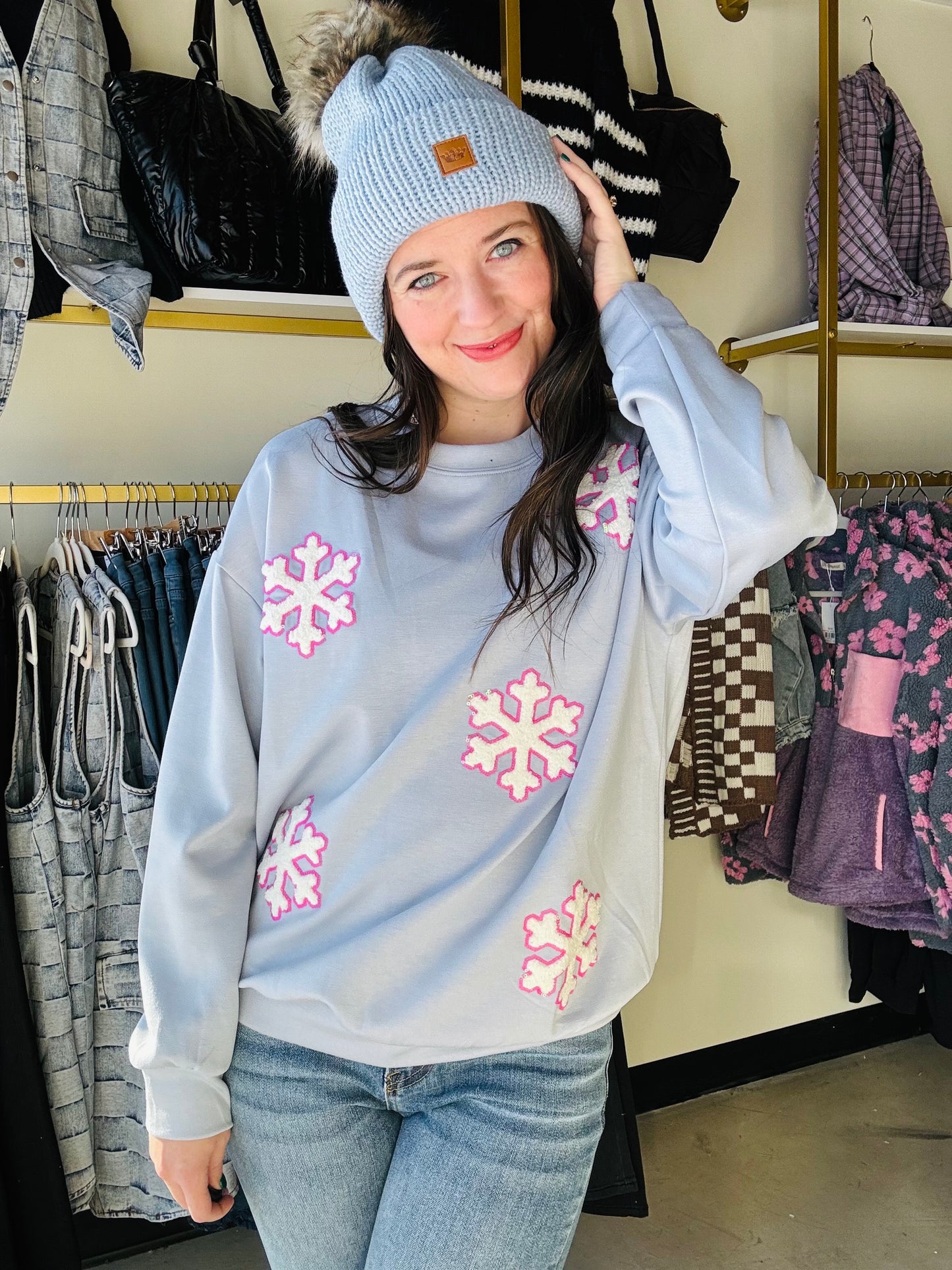 Brand: Jess Lea&nbsp;

Cozy up in style with our Falling Snowflakes Pullover. Made with luxe fabric, this relaxed fit pullover features playful chenille snowflake patches sewn on with a fun pink sequin outline. Stay warm and show off your unique style in this must-have winter essential!