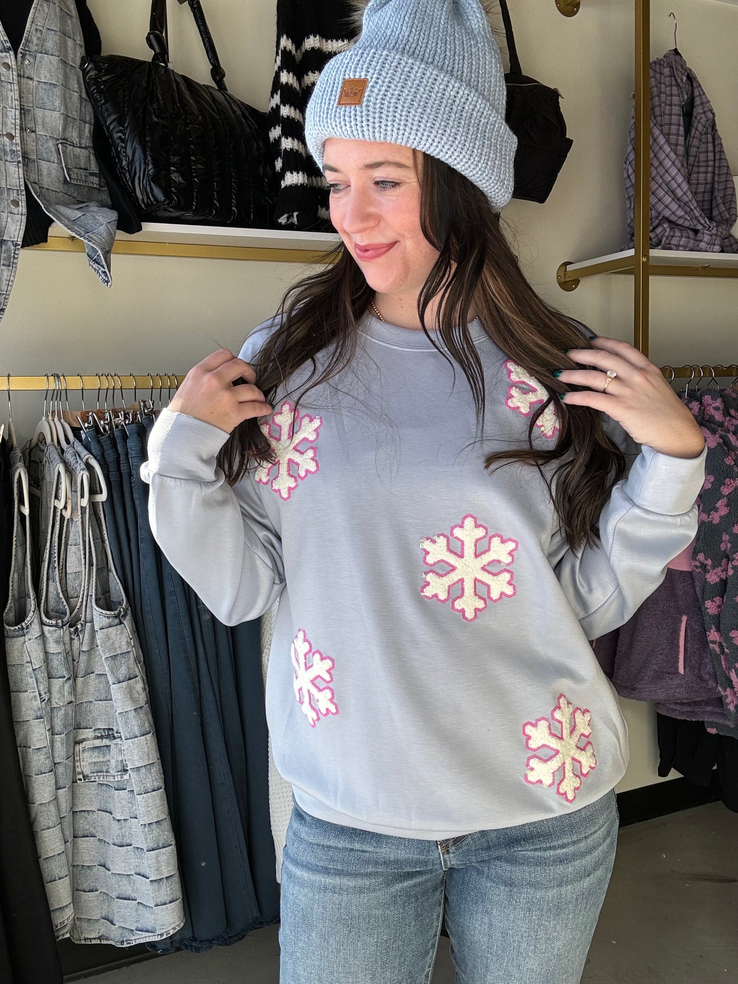 Brand: Jess Lea

Cozy up in style with our Falling Snowflakes Pullover. Made with luxe fabric, this relaxed fit pullover features playful chenille snowflake patches sewn on with a fun pink sequin outline. Stay warm and show off your unique style in this must-have winter essential!