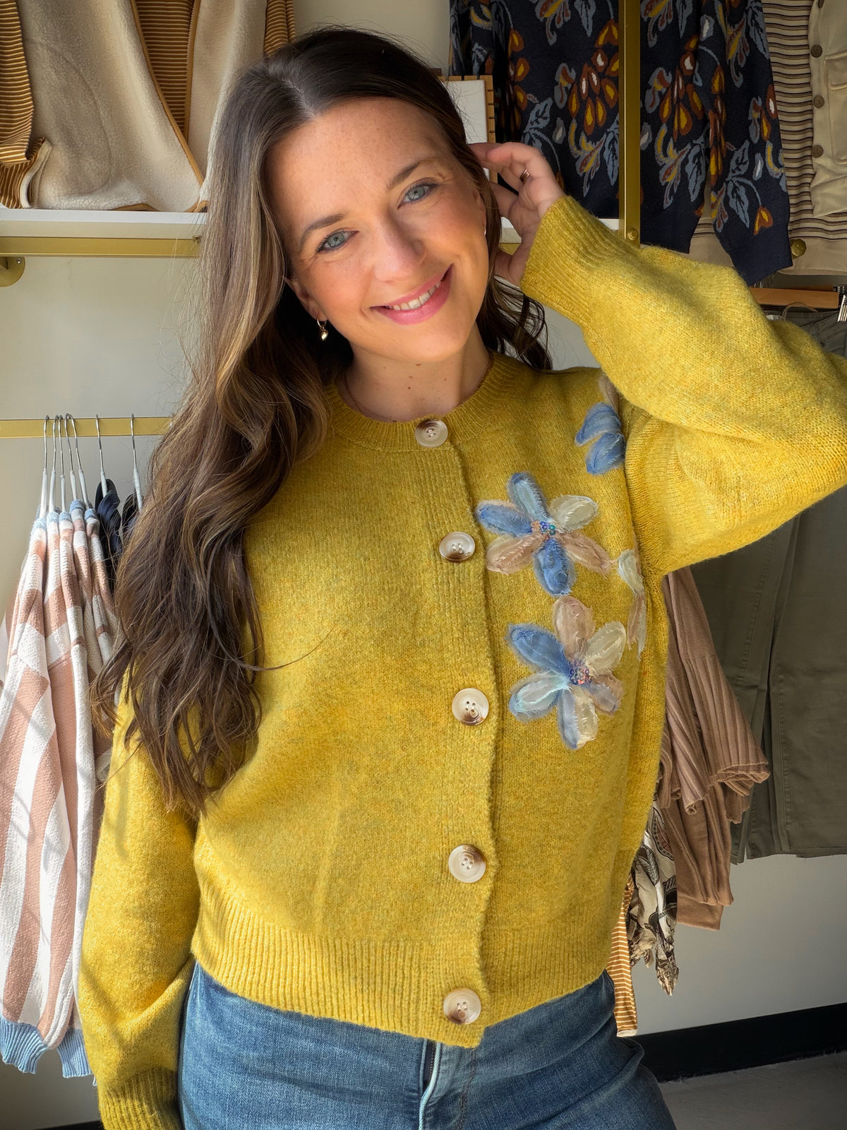 Some pieces just feel special. The&nbsp;Vintage Mustard Floral Button Cardigan by Rain &amp; Rose is one of them — a soft acrylic knit cardigan in rich vintage mustard, adorned with delicate floral appliqué along the front that makes it feel like a wearable heirloom. Classic button-front closure, relaxed silhouette, and feminine detailing that elevates everything from your favorite jeans to a flowy midi skirt.

Why You'll Love It

Delicate floral appliqué detailing — a feminine, one-of-a-kind statement piec