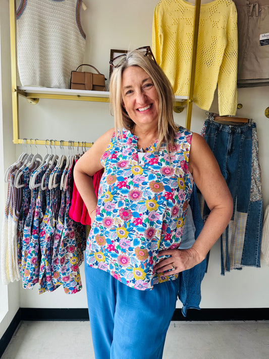 Effortless elegance meets bold style with this blue floral split neck tank. The sleeveless design offers breathable comfort, while the eye-catching floral print adds a pop of color to any warm-weather wardrobe. The distinctive split neckline creates a modern, flattering silhouette perfect for casual outings or layering. A versatile piece that transitions seamlessly from day to night.