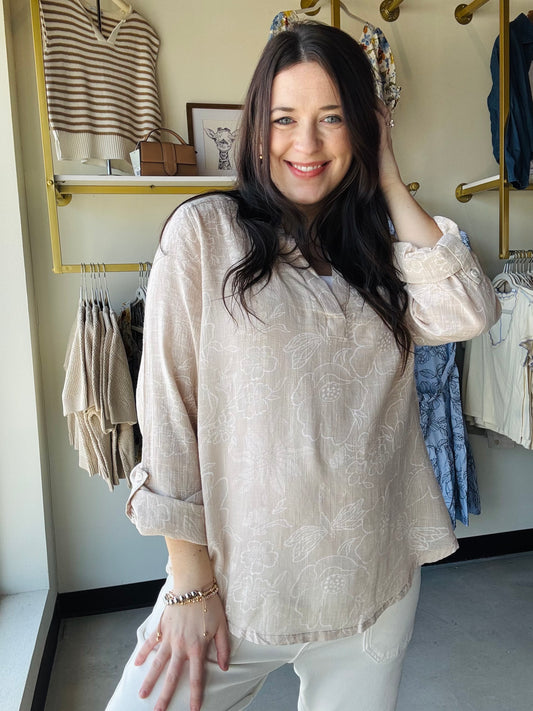Breathable double gauze fabric brings comfort and style to this natural floral woven top. The 3/4 sleeves feature convenient roll-tab closures, allowing you to adjust the fit throughout the day. Its lightweight, airy construction makes it an excellent choice for layering or wearing on its own during warm weather. The subtle botanical print complements any casual wardrobe, whether you're heading to brunch, the office, or weekend adventures. Versatile, comfortable, and effortlessly chic.