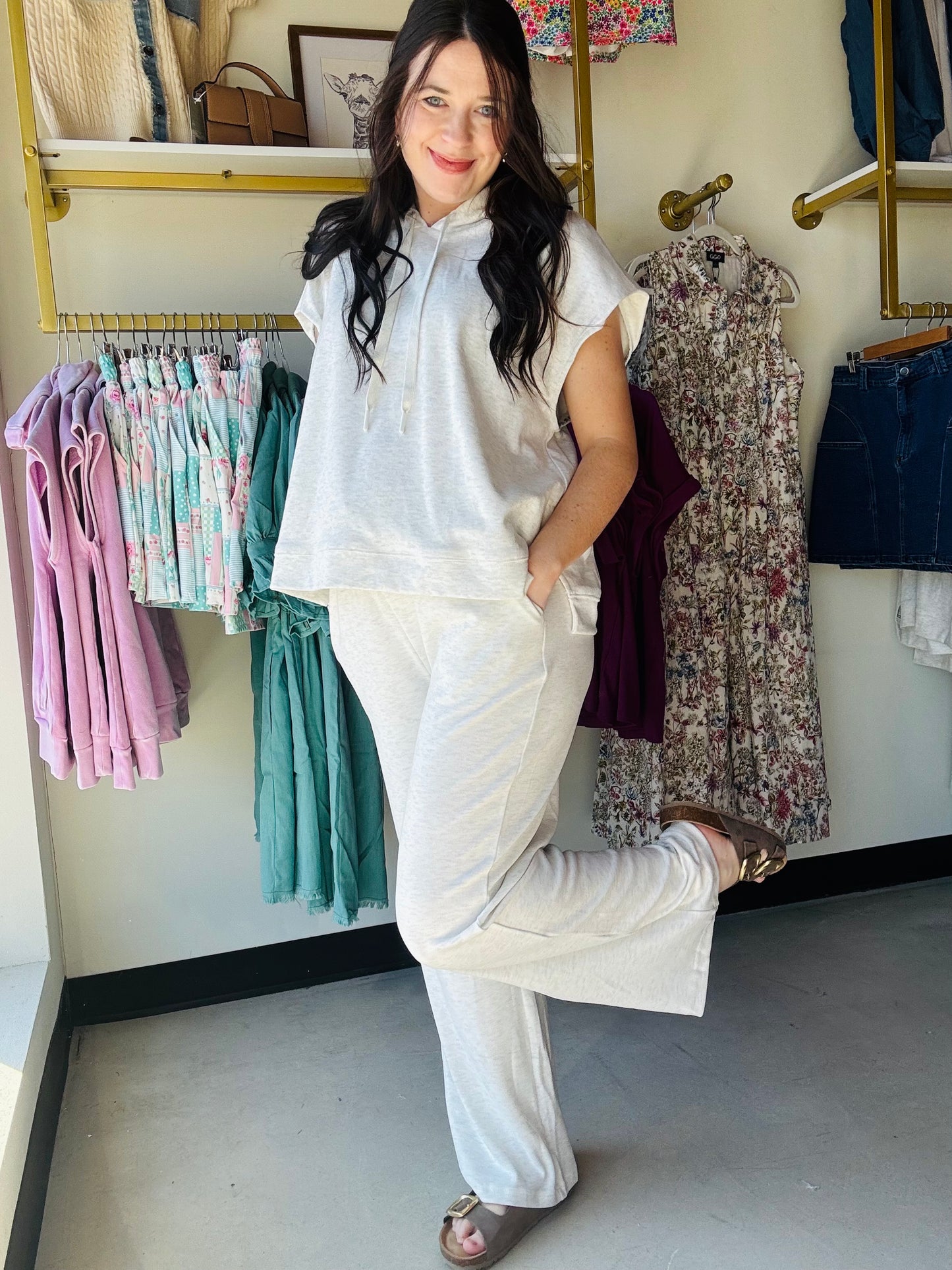 Gigio

Effortless comfort meets contemporary style with this knit sleeveless hoodie featuring delicate floral fabric lining details. The relaxed silhouette provides easy layering versatility, while the thoughtful lining adds a touch of elegance to an everyday essential. Pair it with matching lounge pants for a coordinated, put-together look that transitions seamlessly from home to out and about.