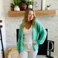 This Green Wave Detail Cardigan Sweater is designed with a unique knit detail, perfect for summer layering. It features a beautiful green color and a classic button-up design. Its lightweight material makes it easy throw on for work with your white denim!