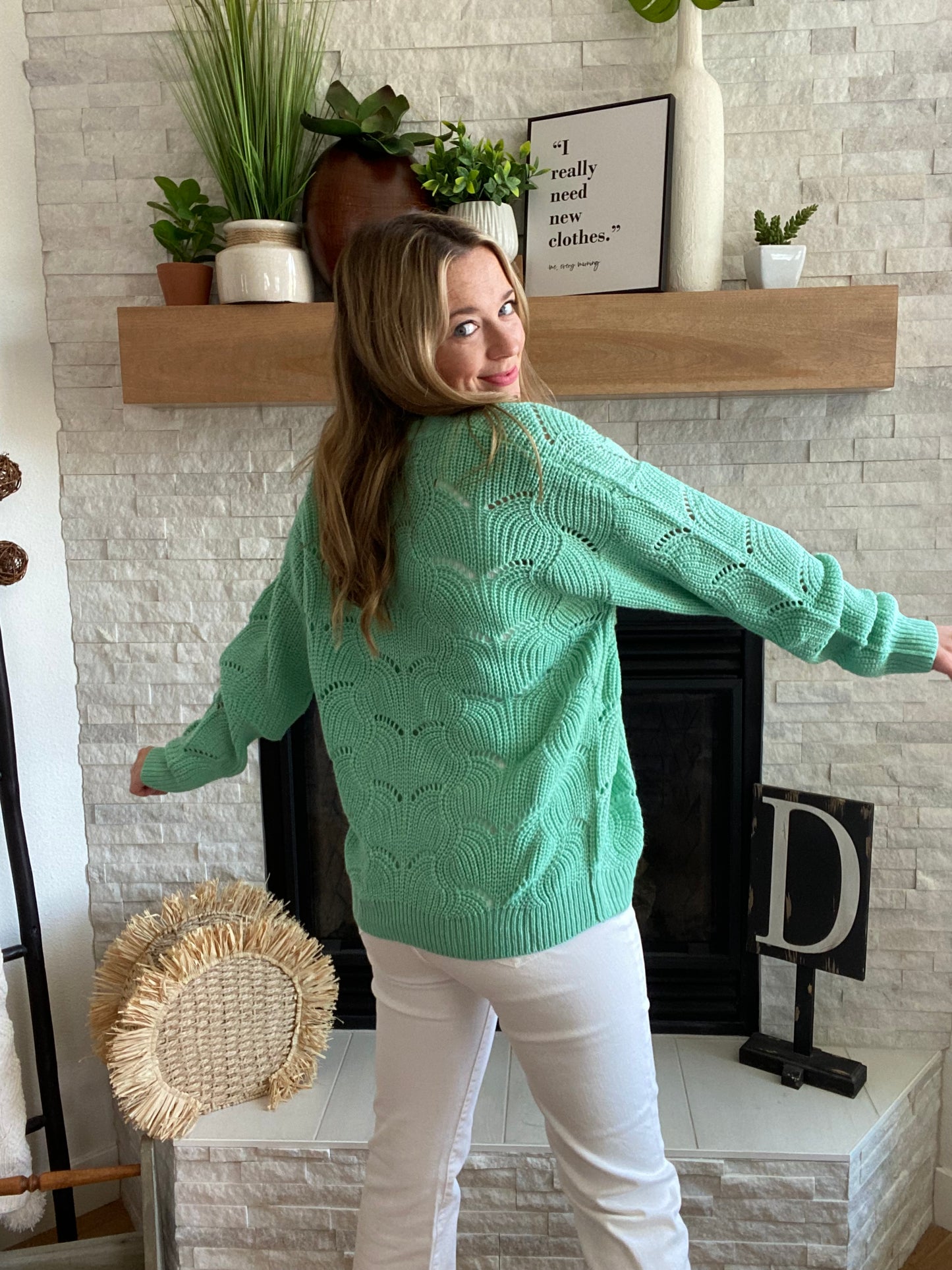 This Green Wave Detail Cardigan Sweater is designed with a unique knit detail, perfect for summer layering. It features a beautiful green color and a classic button-up design. Its lightweight material makes it easy throw on for work with your white denim!