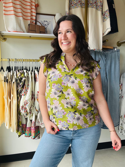 Staccato

Embrace effortless elegance with this breezy Staccato floral blouse, featuring feminine flutter sleeves and a sophisticated ruffle collar. Crafted from lightweight woven fabric, the flattering v-neck and pleated back detail create a chic silhouette perfect for any occasion. Elevate your everyday style with this must-have botanical print top.

Chic ruffle collar and V-neck.
Feminine flutter sleeves add movement.
Elegant pleated back for drape.
Lightweight, breathable woven fabric.
Versatile olive a