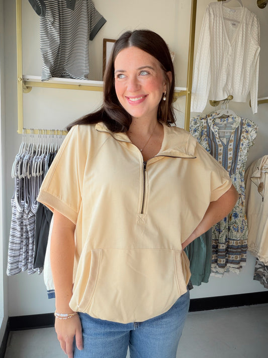 The hoodie, reimagined for warmer days. The Taupe Short Sleeve Hoodie by Bibi gives you all the cozy, laid-back energy of your favorite hoodie — minus the sleeves. It's the perfect transitional piece for those in-between days when you want something casual and comfortable without overheating.

In a versatile taupe tone that pairs with just about everything, this relaxed sweatshirt-style top is an easy grab for errands, coffee runs, or lounging in style. Wear it with biker shorts, denim, or joggers for an ef