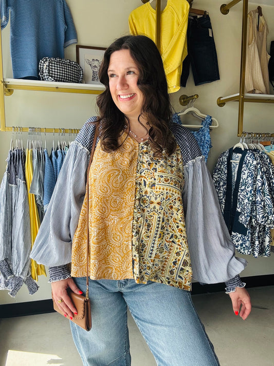Oli &amp; Hali

This Oli &amp; Hali mixed print blouse combines artisan mineral wash details with a vibrant honey and blue boho aesthetic. Crafted from a breathable rayon-viscose blend, its relaxed silhouette delivers effortless style and premium all-day comfort

Unique artisan mineral wash finish
Breezy, effortless relaxed fit
Stunning mixed boho print pattern
Lightweight, breathable viscose-rayon blend
Flattering fit, true to size
Statement voluminous balloon sleeves
Versatile day-to-night styling
