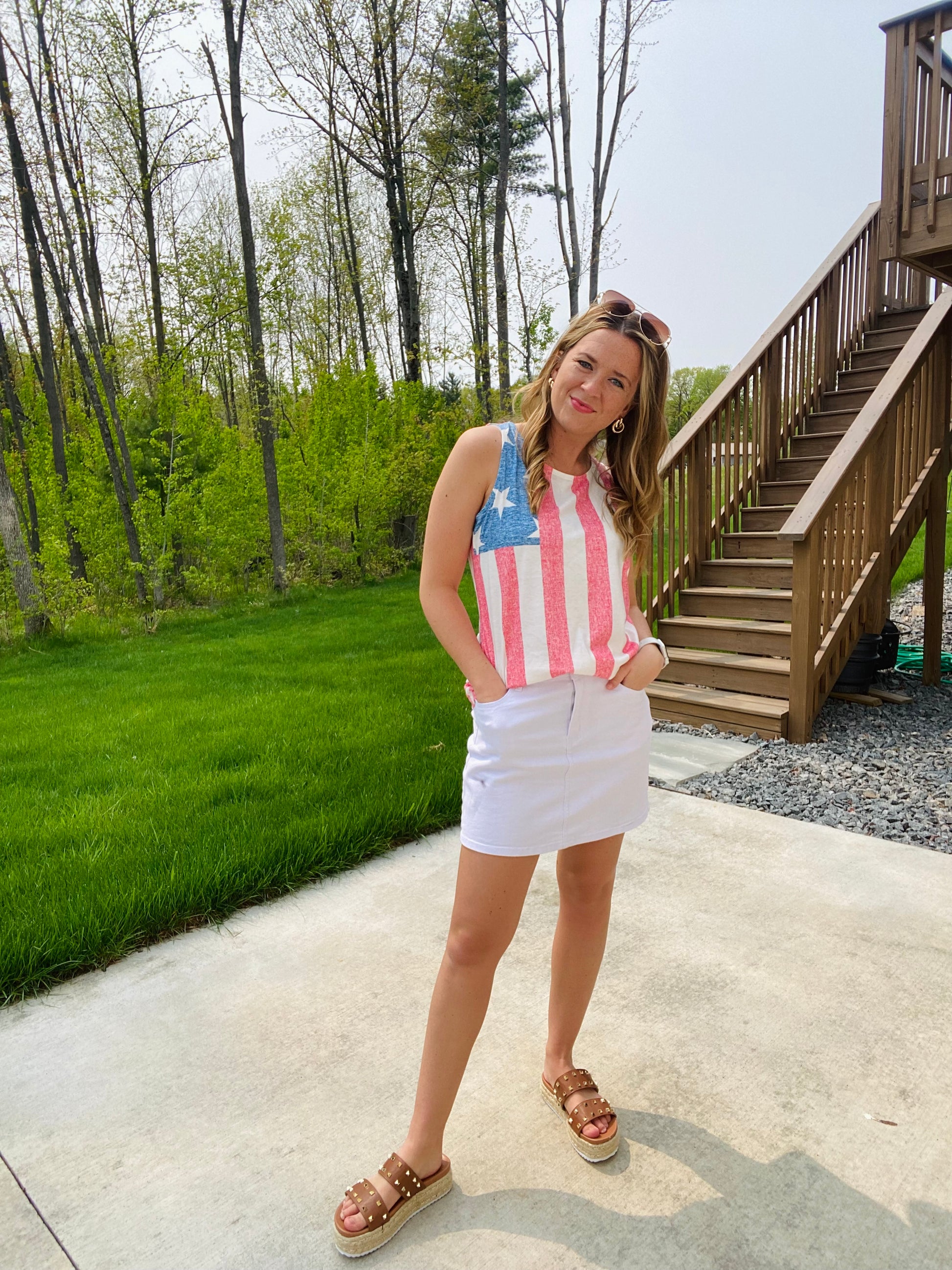 This Miss Americana Flag Tank Top is perfect for your summer patriotic wardrobe. The high neckline, festive American flag design, and patriotic colors make it ideal for 4th of July and Memorial Day celebrations. Wear it dressed up with a denim skirt or down with black athletic shorts for any summer occasion.