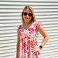 This Shades of Pink Floral Top is the perfect addition to your summer wardrobe. Its high neckline and flutter sleeve are perfect for sunny days, while the bright colors and peplum top add an extra touch of style. Accessorize to create a look that is all your own.