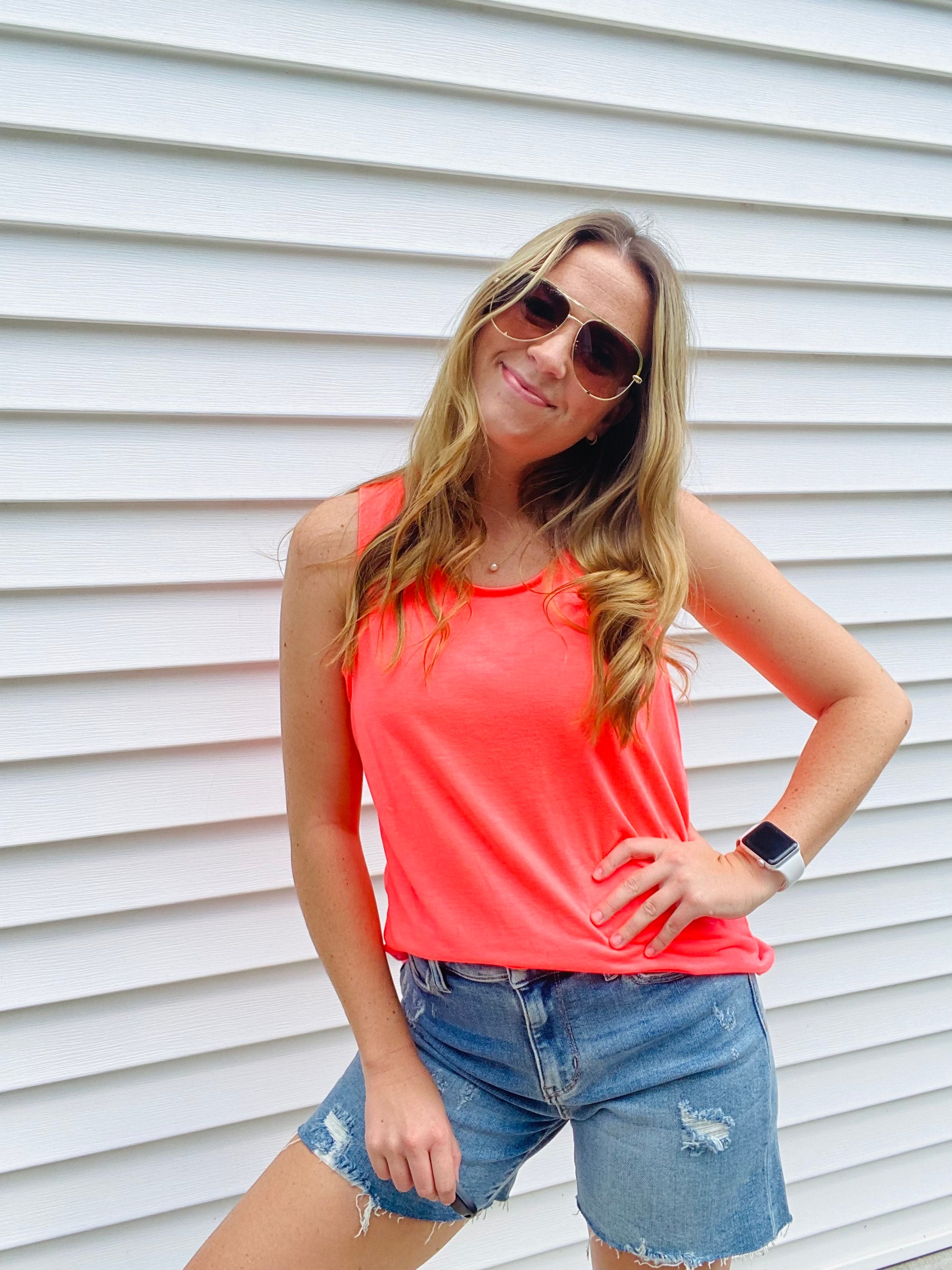 The Neon Coral Tiffany Tank is the perfect combination of comfy and trendy. Crafted with a stretchy fabric for ultimate comfort, this tank features a scoop neck and wide straps to ensure a secure fit and bold neon colors to make a statement. Feel fashionable and secure with this essential tank.