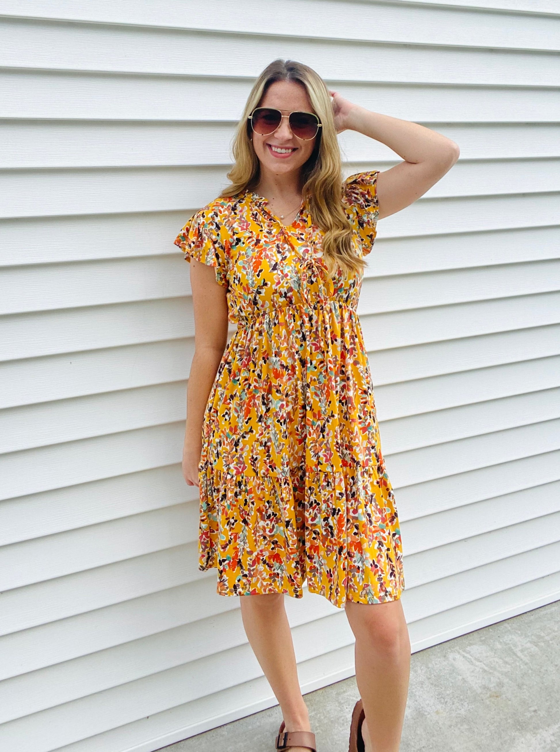 This Honey Ruffle Floral Dress is perfect for any occassion. Boasting beautiful features such as a v-keyhole neck with string-tied ruffle frill, a babydoll fit and flare silhouette, and tiered ruffle hem, this dress offers a flattering and elegant look. The vibrant multicolor floral print knit pairs perfectly with the side pockets for a practical and stylish dress.