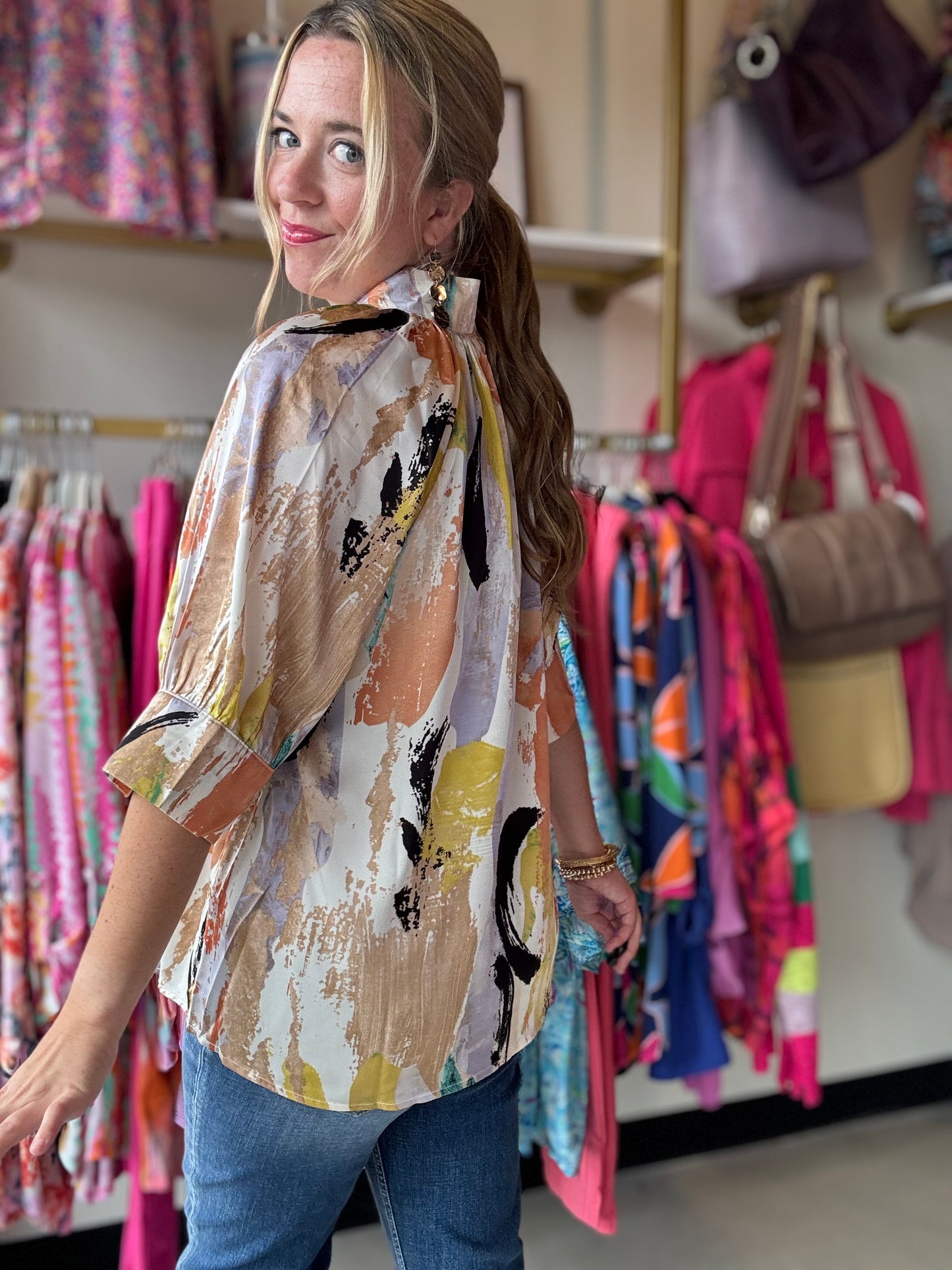 Add a pop of fun to your wardrobe with our Taupe Multi Satin Blouse! Made with soft satin fabric, this blouse features a colorful printed design, flattering v-neckline, and stylish open and cuff sleeves for a relaxed fit. We love the abstract pattern while still remaining neutral!&nbsp;  Anniewear Brand