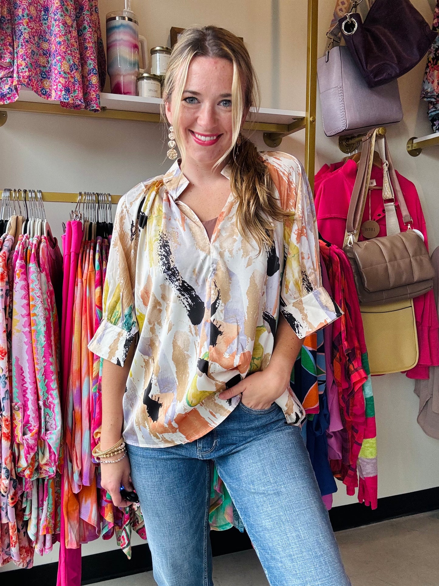 Add a pop of fun to your wardrobe with our Taupe Multi Satin Blouse! Made with soft satin fabric, this blouse features a colorful printed design, flattering v-neckline, and stylish open and cuff sleeves for a relaxed fit. We love the abstract pattern while still remaining neutral!&nbsp;  Anniewear Brand