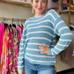 Transition from summer to fall in style with our Blue and White Summer Sweater. This lightweight sweater boasts a beautiful low gauge texture and a slouchy fit for a fun and playful look. Perfect for those chilly nights, this striped sweater is a must-have for any wardrobe.  Bibi Brand