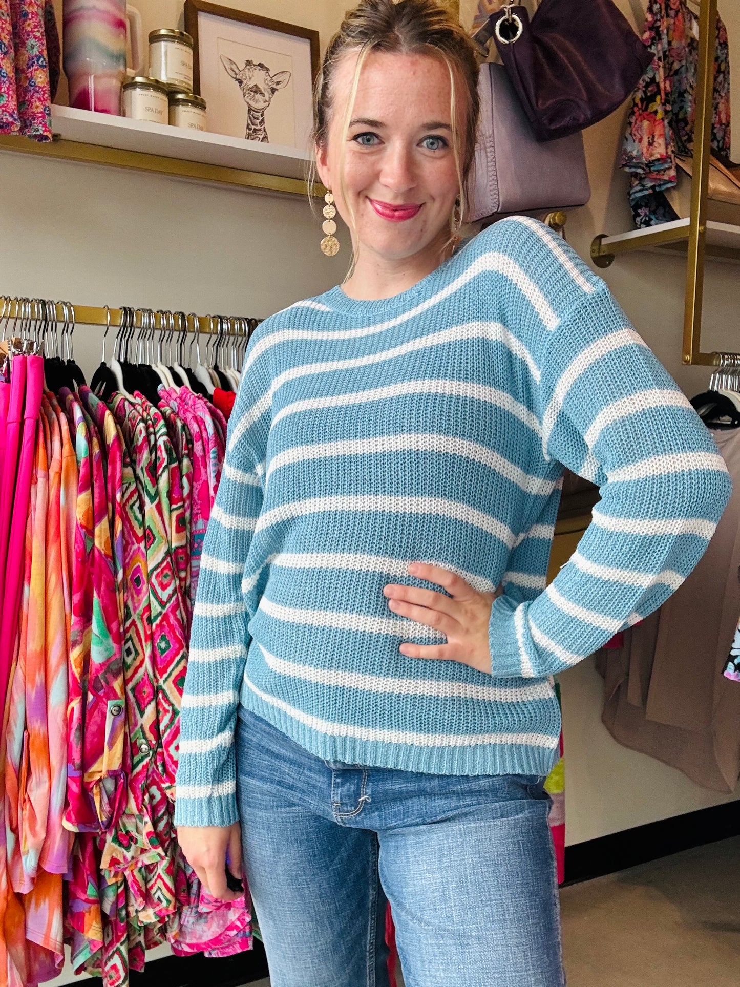 Transition from summer to fall in style with our Blue and White Summer Sweater. This lightweight sweater boasts a beautiful low gauge texture and a slouchy fit for a fun and playful look. Perfect for those chilly nights, this striped sweater is a must-have for any wardrobe.  Bibi Brand