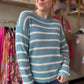 Transition from summer to fall in style with our Blue and White Summer Sweater. This lightweight sweater boasts a beautiful low gauge texture and a slouchy fit for a fun and playful look. Perfect for those chilly nights, this striped sweater is a must-have for any wardrobe.  Bibi Brand