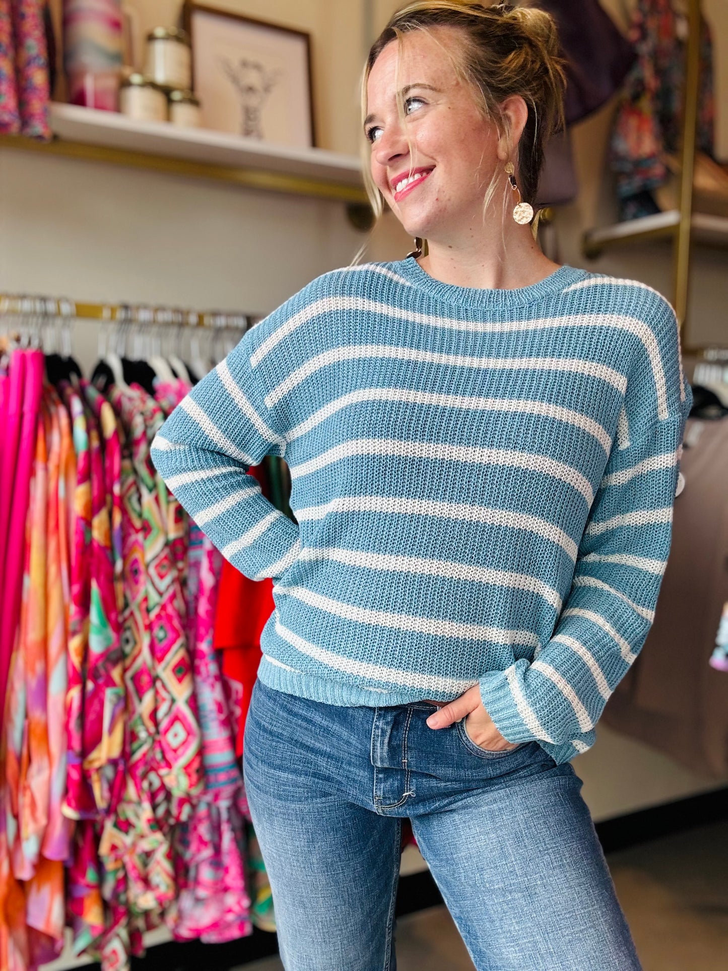 Transition from summer to fall in style with our Blue and White Summer Sweater. This lightweight sweater boasts a beautiful low gauge texture and a slouchy fit for a fun and playful look. Perfect for those chilly nights, this striped sweater is a must-have for any wardrobe.  Bibi Brand