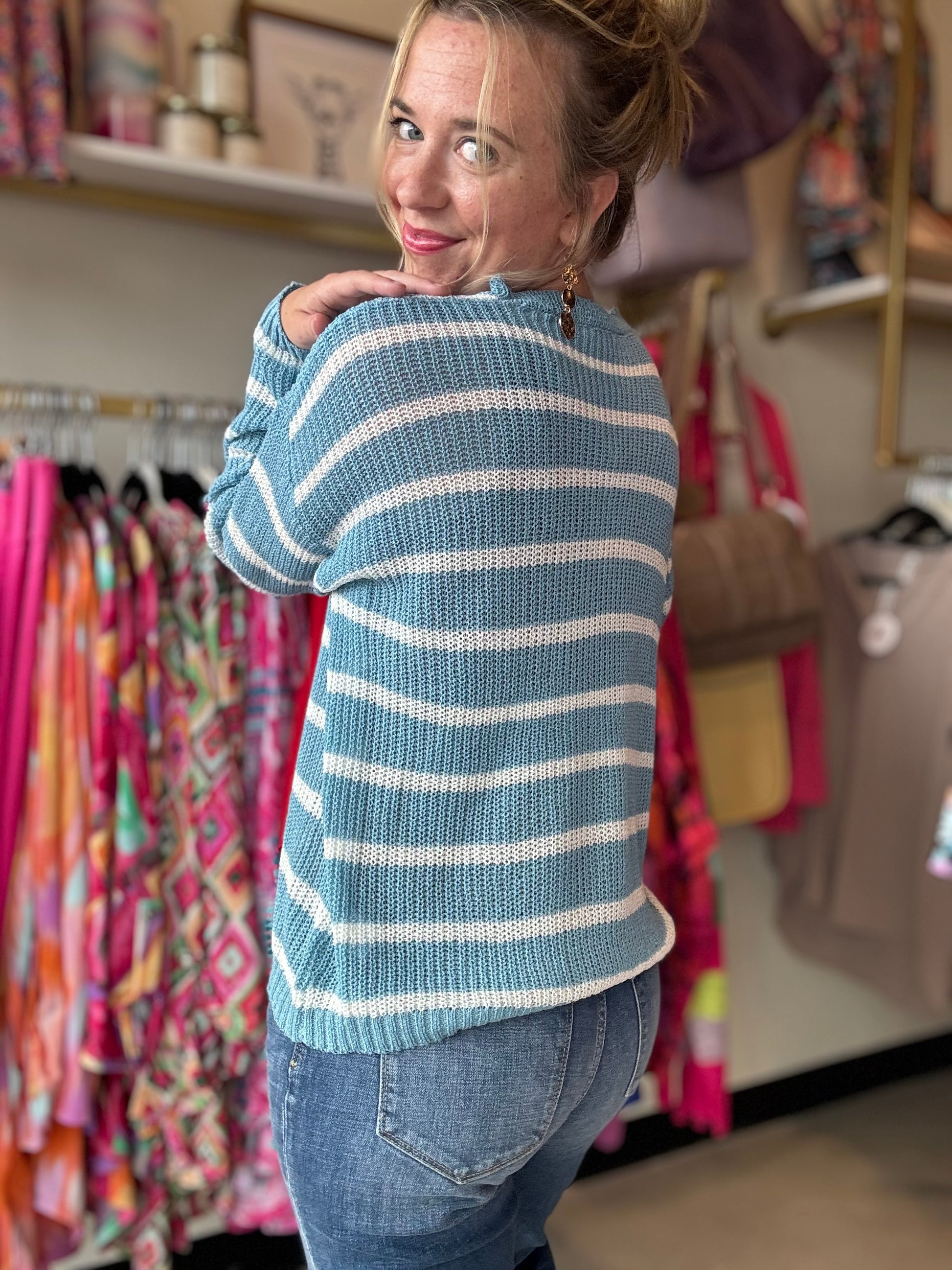 Transition from summer to fall in style with our Blue and White Summer Sweater. This lightweight sweater boasts a beautiful low gauge texture and a slouchy fit for a fun and playful look. Perfect for those chilly nights, this striped sweater is a must-have for any wardrobe.  Bibi Brand