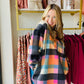 This Multi Checker hoodie is sure to be a must-have for the season! It comes in trending colors for fall and is made of brushed fleece with functioning buttons and a breast pocket. The oversized fit gives a comfortable and relaxed look. Stay warm and fashionable with this stylish hoodie.  Bibi Brand