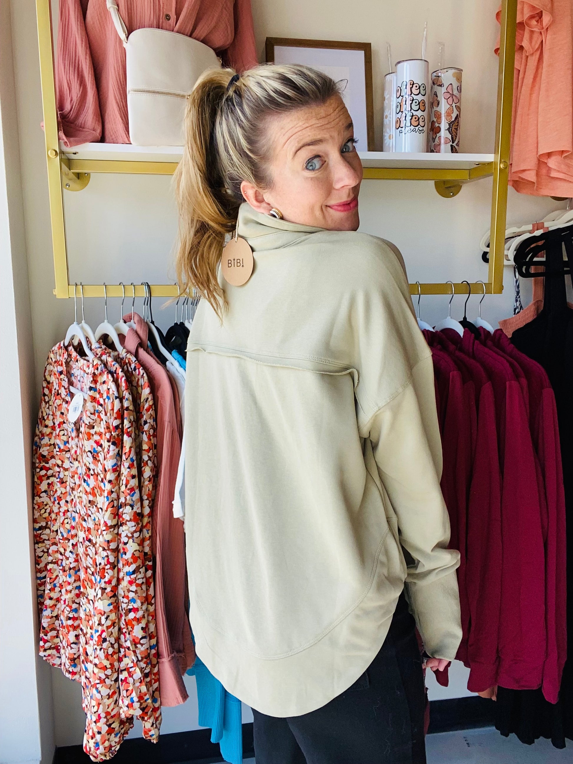 Experience comfort and style with this Ash Green Deep V Cuff Pullover. It has a vintage wash finish to give you an effortless look paired with a unique ring detail for a subtle touch of style. Its versatile design allows you to pair it with yoga pants or jeans, making it perfect for both laid-back and casual.  Bibi Brand 
