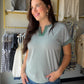 Effortlessly chic, the Jade Stripe Split Neck Top by Staccato is a wardrobe essential that blends laid-back style with a polished finish. Featuring a flattering split neckline, contrast color trim, and a breezy extended short sleeve, this pinstriped knit top pairs beautifully with denim, trousers, or your favorite wide-leg pants.

Details:

Split neckline with color-trimmed detail
Extended short sleeves
Pinstripe pattern in jade
Relaxed, easy-to-wear fit
Available in sizes Small – XL
