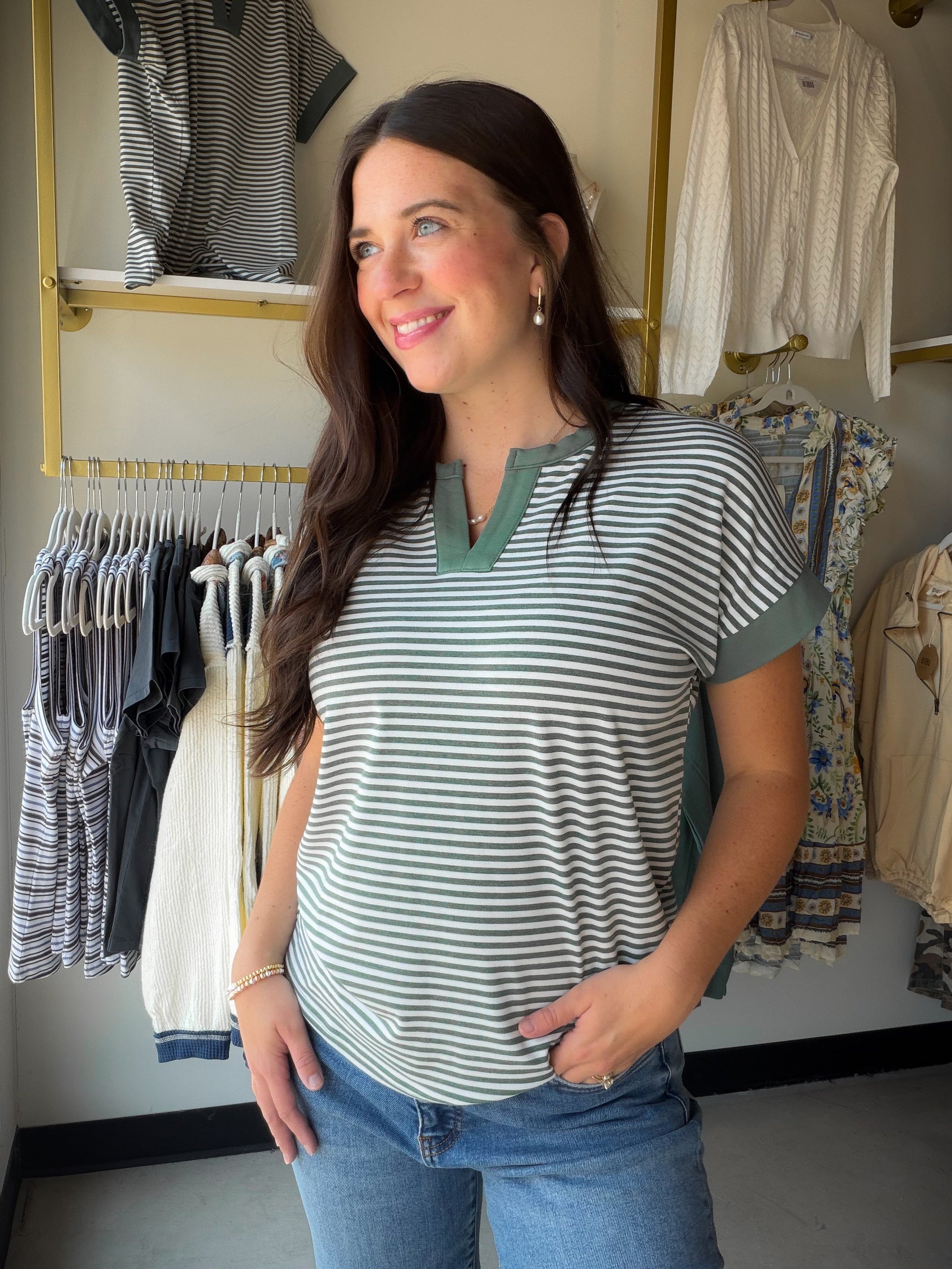 Effortlessly chic, the Jade Stripe Split Neck Top by Staccato is a wardrobe essential that blends laid-back style with a polished finish. Featuring a flattering split neckline, contrast color trim, and a breezy extended short sleeve, this pinstriped knit top pairs beautifully with denim, trousers, or your favorite wide-leg pants.

Details:

Split neckline with color-trimmed detail
Extended short sleeves
Pinstripe pattern in jade
Relaxed, easy-to-wear fit
Available in sizes Small – XL
