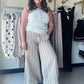Easel

Elevate your sun-drenched style with these breathable linen-blend palazzo pants featuring slimming vertical stripes and an effortless wide-leg silhouette. Designed with a high-rise elastic waistband and boho-chic tassel ties, they offer the perfect blend of coastal elegance and all-day comfort.

Slimming vertical stripes elongate legs
Breathable linen keeps you cool
Ultra-comfortable high-rise elastic waistband
Chic drawstring with tassel ends
Functional side pockets for essentials
Effortless relaxed
