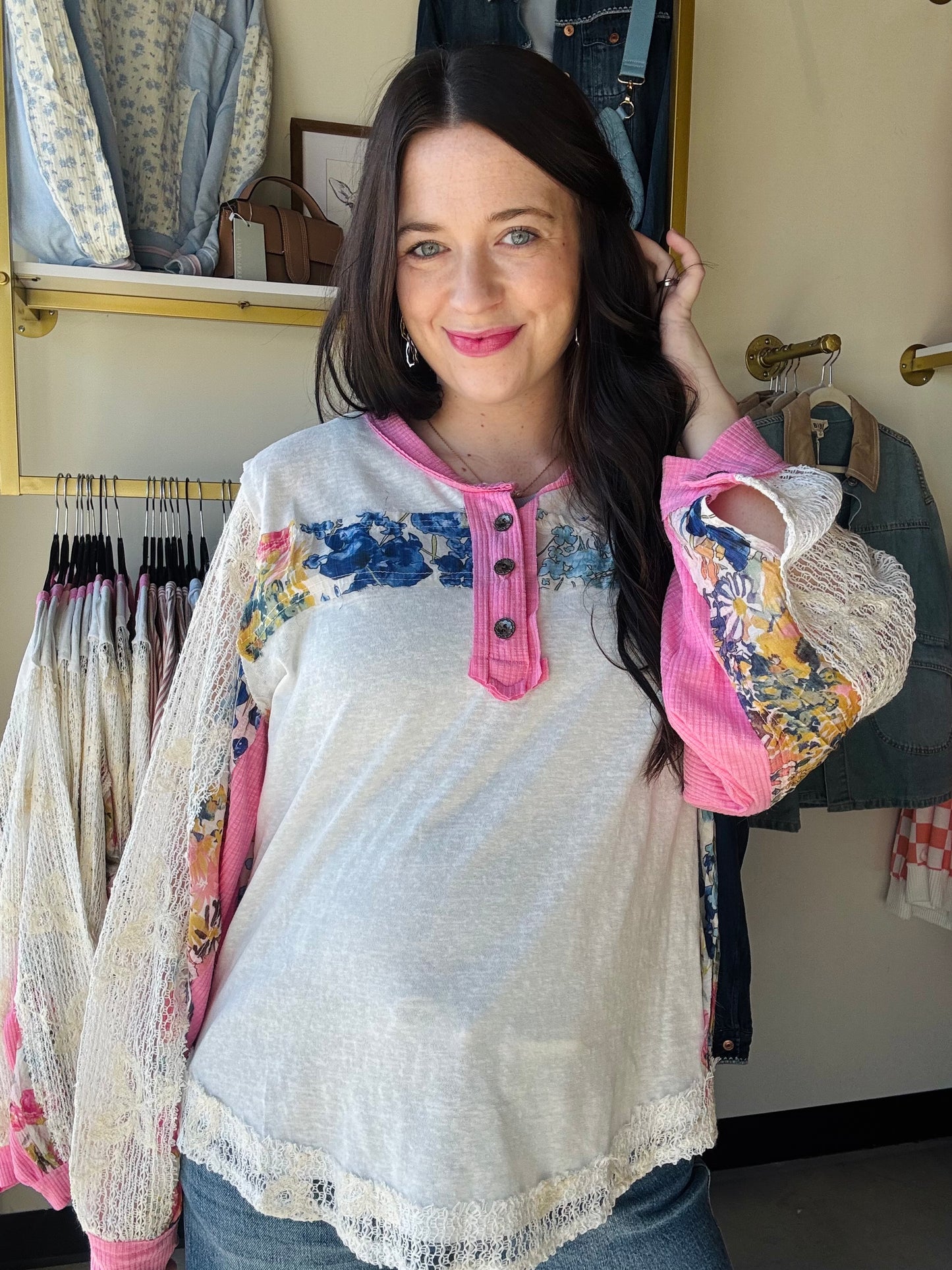 POL

Embrace effortless spring style with this charming lace trim patch top. Delicate lace sleeves and pink accents frame a beautiful floral pattern, while functioning buttons offer easy layering versatility. The oversized silhouette delivers that coveted relaxed fit perfect for casual days and breezy weather. Whimsical details meet everyday comfort in a piece that feels as good as it looks.