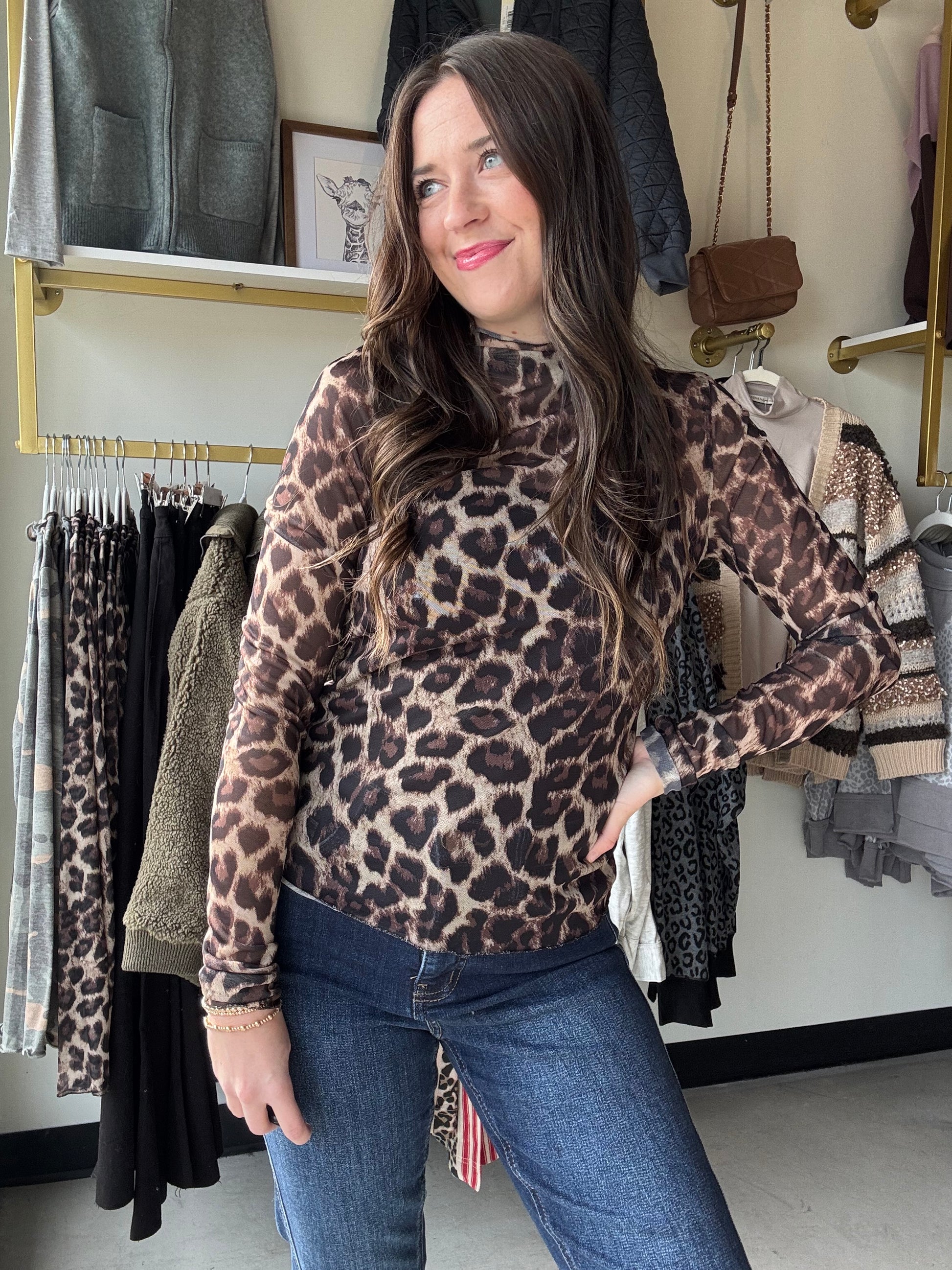 Unleash your wild side with this Leopard Ruffle Trim Mesh Top! Featuring a sheer mesh fabric with bold leopard print and playful ruffle detailing along the sleeves and hem, this long-sleeved top adds a flirty edge to any outfit. Perfect for layering or wearing solo, it brings effortless style and a touch of fierce fun to your wardrobe.

Bibi