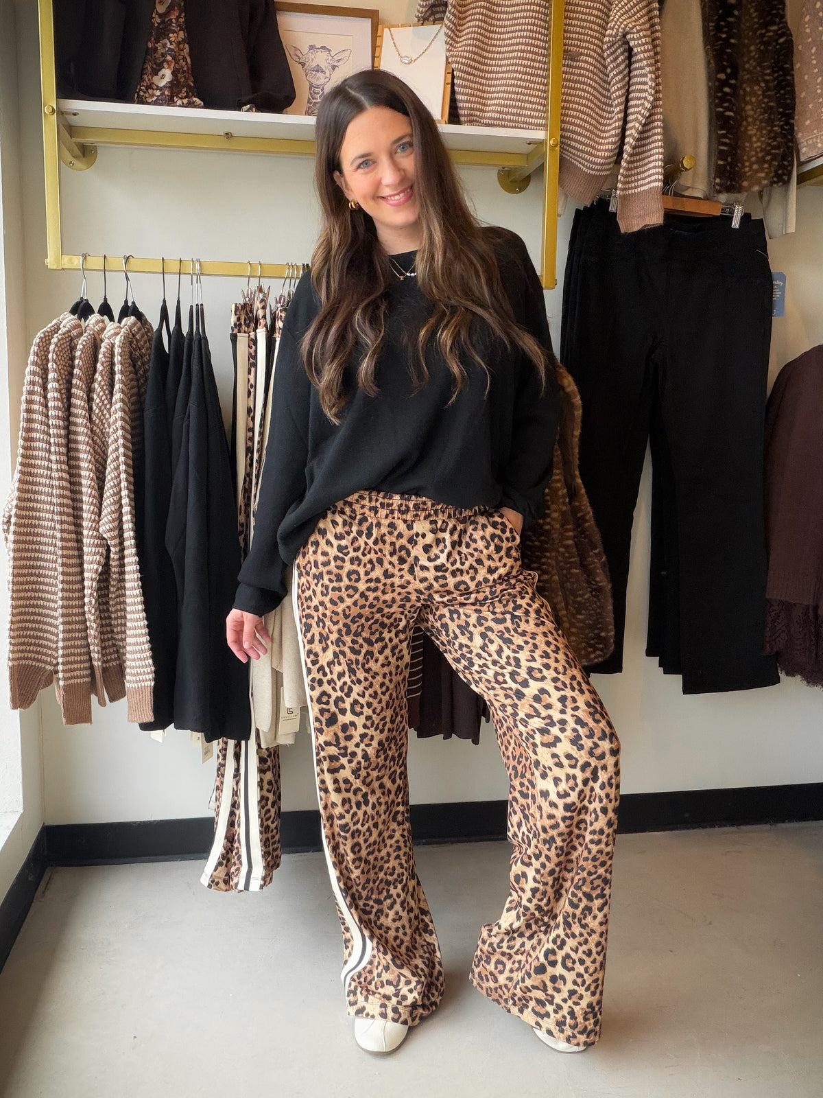 The Leopard Butter Soft Track Pants by Rae Mode bring a little wild side to your off-duty wardrobe. The butter soft fabric feels amazing from the very first wear, and the bold allover leopard print turns a cozy staple into a statement.

A sporty side stripe runs down each leg for that classic track pant finish, while the relaxed fit and easy elastic waistband keep you comfortable from morning coffee runs to movie night on the couch.

Details to Love

Butter soft fabric
Bold allover leopard print
Sporty side
