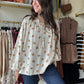 This Oatmeal Dainty Floral Blouse features lightweight linen fabric that drapes elegantly, complemented by flowing balloon sleeves for a refined silhouette. The tie neck detail adds a classic touch, while the cinched cuffs provide subtle structure and shape to the sleeves. Ideal for versatile styling, this blouse blends comfort with sophisticated design.

Bibi