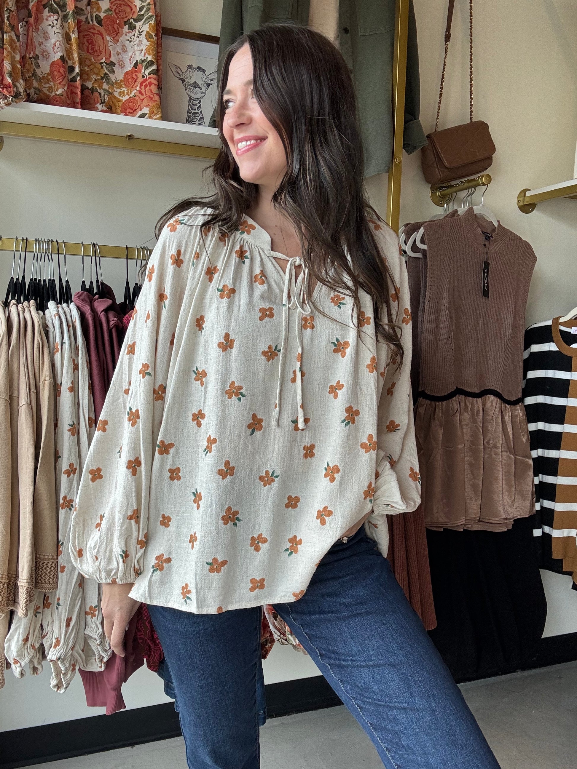This Oatmeal Dainty Floral Blouse features lightweight linen fabric that drapes elegantly, complemented by flowing balloon sleeves for a refined silhouette. The tie neck detail adds a classic touch, while the cinched cuffs provide subtle structure and shape to the sleeves. Ideal for versatile styling, this blouse blends comfort with sophisticated design.

Bibi