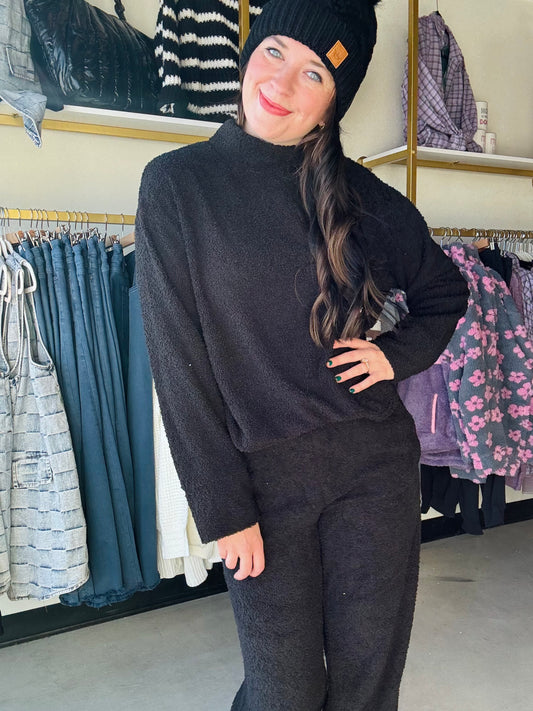 Upgrade your loungewear collection with our Mind You Mock Neck Top. This cozy black top features a high-end mock neck, perfect for staying comfortable and stylish. Ideal for both leisure and work from home settings, this top is a must-have for any fashion-forward individual.

Brand: Sadie &amp; Sage

Complete the set with the Mind You Wide Leg Pants