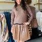 Gigio

Elevate your wardrobe with the Mocha Knit Sweater Dress, featuring a sophisticated mock neck and a textured knit vest design. The contrasting wavy border adds a refined visual detail, seamlessly transitioning into a smooth satin skirt that offers both comfort and elegance. This dress combines cozy knitwear with luxurious satin, making it an ideal choice for polished, versatile styling in cooler seasons.