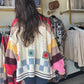 POL

Cozy up in the Ivory Multi Crochet Sweater, featuring an open cardigan style and fun balloon sleeves for an effortlessly oversized look. Crafted from soft chenille, it’s topped with a charming handmade patch and a pointed striped pattern that adds a playful twist to your everyday outfit. Perfect for layering and bringing joy to cooler days!