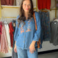 Boho-chic meets artisan craftsmanship. The V Neck Embroidered Fringe Top features rich embroidery and a playful fringe hem that give it a one-of-a-kind, handcrafted feel. A band collar, 3/4 sleeves, and button-front silhouette keep it polished, while the soft Lyocell fabric drapes effortlessly for all-day comfort.

Band collar with button-front closure
3/4 sleeve length
Rich embroidery and fringe hem detail
Soft, flowing Lyocell fabric
Available in sizes S–1X