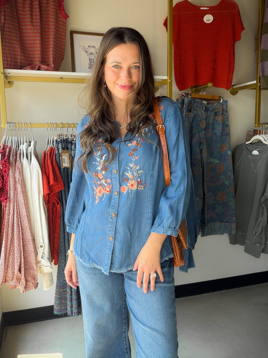 Boho-chic meets artisan craftsmanship. The V Neck Embroidered Fringe Top features rich embroidery and a playful fringe hem that give it a one-of-a-kind, handcrafted feel. A band collar, 3/4 sleeves, and button-front silhouette keep it polished, while the soft Lyocell fabric drapes effortlessly for all-day comfort.

Band collar with button-front closure
3/4 sleeve length
Rich embroidery and fringe hem detail
Soft, flowing Lyocell fabric
Available in sizes S–1X