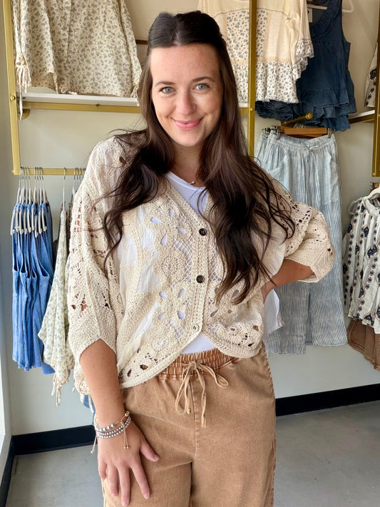 The layer you didn't know you needed. The Natural Batwing Crochet Cardigan brings that effortless, throw-it-on energy with a relaxed batwing silhouette and delicate crochet craftsmanship that feels anything but casual.

A V-neckline and button-down front keep it versatile — wear it open as a breezy layer over your favorite summer dress, or buttoned up as a standalone top. The high-low hem adds a modern touch, and the airy cotton-blend crochet makes it the kind of piece you'll reach for on repeat all season 