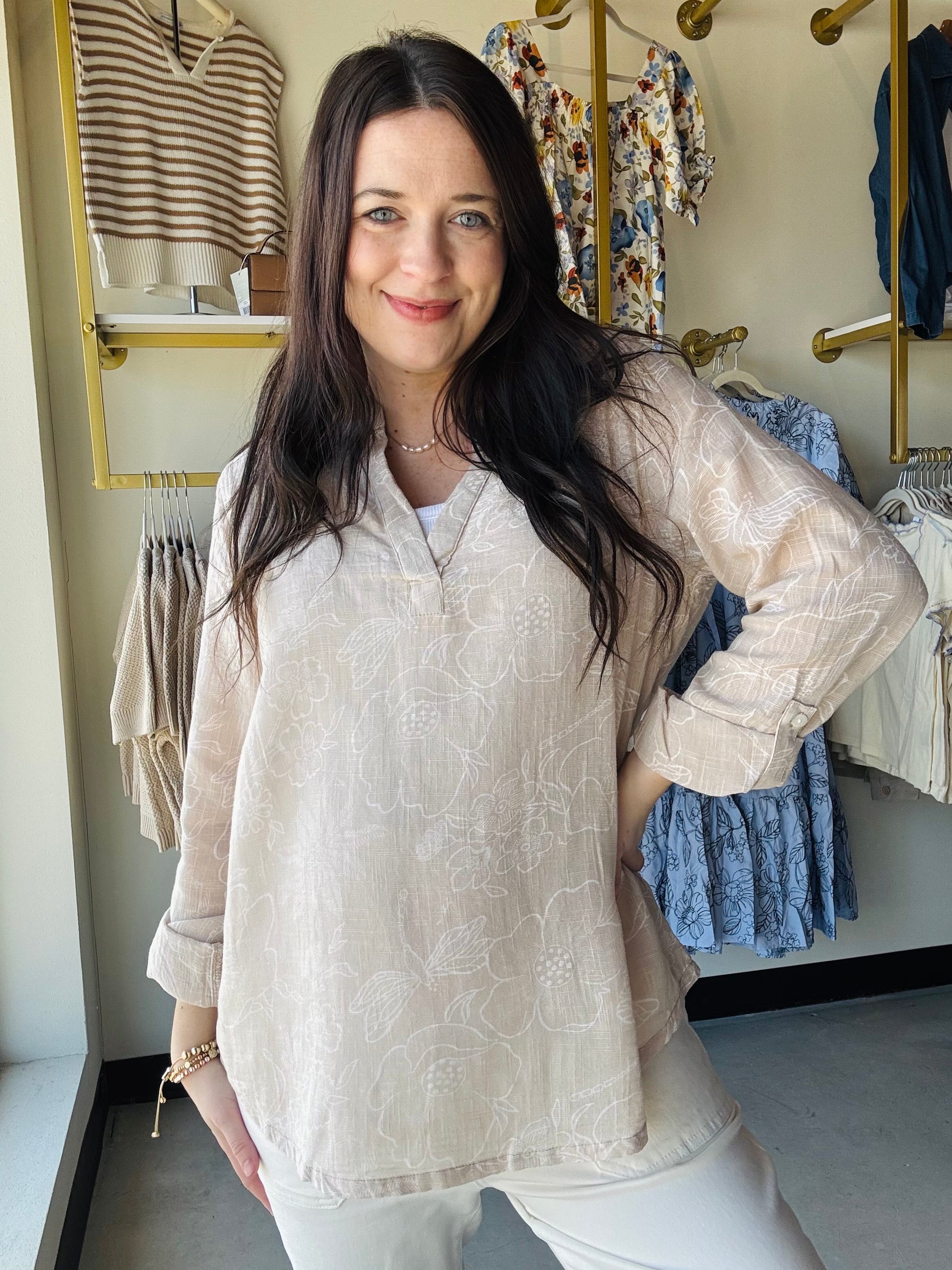Breathable double gauze fabric brings comfort and style to this natural floral woven top. The 3/4 sleeves feature convenient roll-tab closures, allowing you to adjust the fit throughout the day. Its lightweight, airy construction makes it an excellent choice for layering or wearing on its own during warm weather. The subtle botanical print complements any casual wardrobe, whether you're heading to brunch, the office, or weekend adventures. Versatile, comfortable, and effortlessly chic.