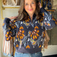 Casual cool, fully refined. The&nbsp;Navy Printed Half Zip Popover by Rain &amp; Rose takes the laid-back ease of a pullover and gives it a polished edge — a printed navy design with a half-zip neckline that adds just enough detail to make it a standout. Soft, drapey fabric that feels luxurious on and looks intentional every time.

Why You'll Love It

Navy printed design — rich, versatile, and effortlessly elevated
Half-zip neckline — a functional detail that adds a sporty-chic finish
Popover silhouette — r