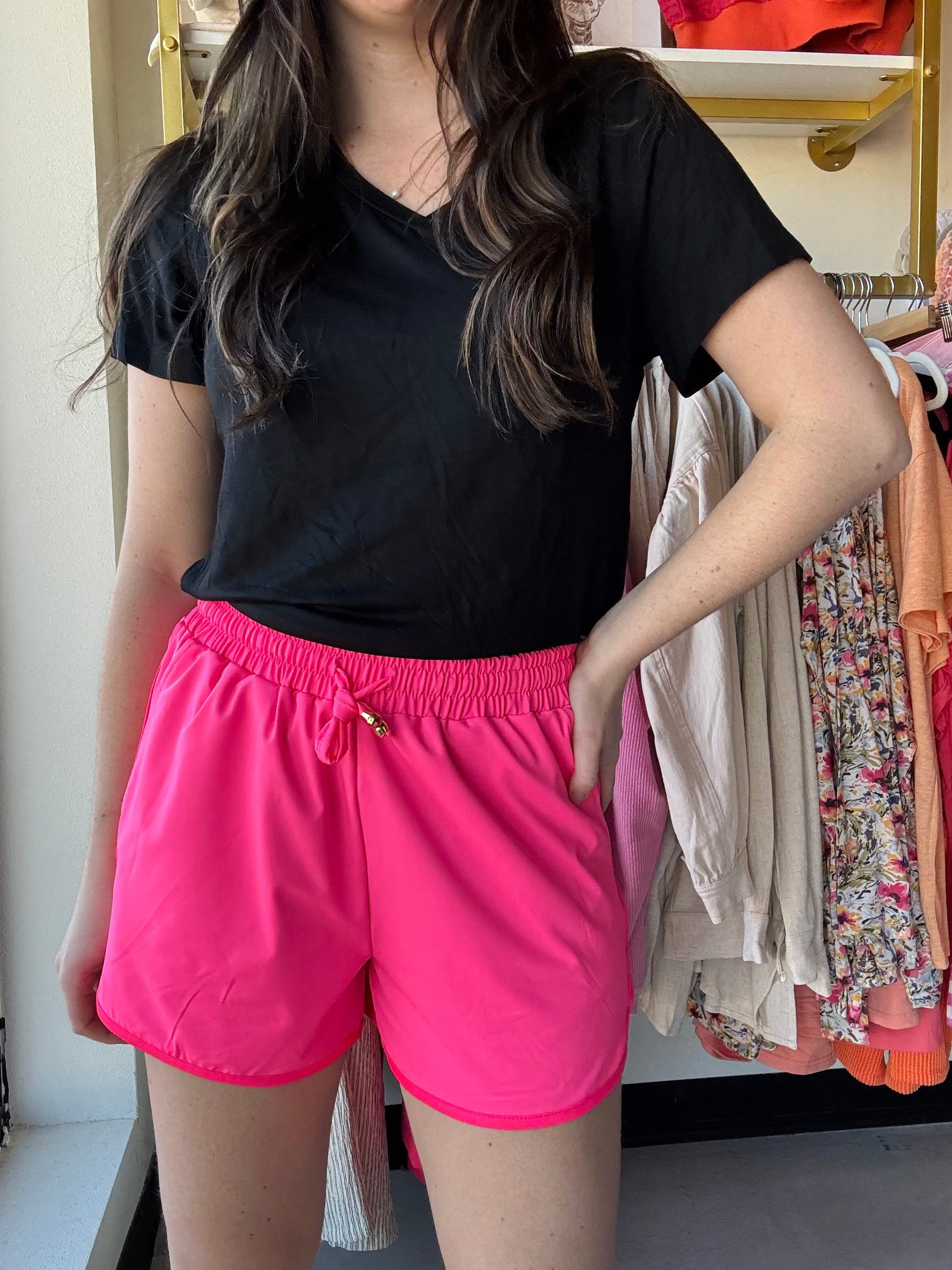 These mid-rise solid neon coral shorts are so perfect for the spring and summer and even to wear in to the fall! Get the effortless yet chic look with these shorts. They feature a mid-rise, tie waist drawstring, &amp; side pockets. These are a relaxed fit.