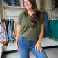 The&nbsp;Olive Pointelle Stripe Sweater by Staccato is a warm-weather knit done right. Delicate pointelle striping adds beautiful texture and visual interest, while the Y-split half-button neckline brings a playful, feminine touch to a classic silhouette.

Made from 100% Cotton, this short sleeve sweater is breathable and lightweight — perfect for layering into fall or wearing solo on a breezy day. The rich olive hue pairs effortlessly with denim, white trousers, or your favorite skirt.

Pointelle stripe kn