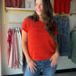 A rich dark orange hue meets delicate pointelle knit in this easy short-sleeve sweater. The wide crew neck and relaxed silhouette make it a versatile layering piece — wear it solo on a cool summer evening or over a collared shirt for a polished, textured look.

Wide crew neckline
Short sleeve silhouette
Pointelle knit texture
100% Cotton — breathable and soft
Relaxed, easy fit