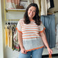 Haptics

Elevate your sunshine style with this airy, netted crochet sweater top featuring vibrant orange stripes and feminine flutter sleeves. This lightweight, scalloped-hem beauty offers the perfect blend of boho charm and breathable comfort for effortless daytime layering.

Airy netted knit for summer comfort.
Playful scalloped hem adds feminine flair.
Flutter sleeves for a relaxed silhouette.
Bold orange stripes pop against cream.
Perfect for layering over camis.
Soft, lightweight crochet sweater knit.
