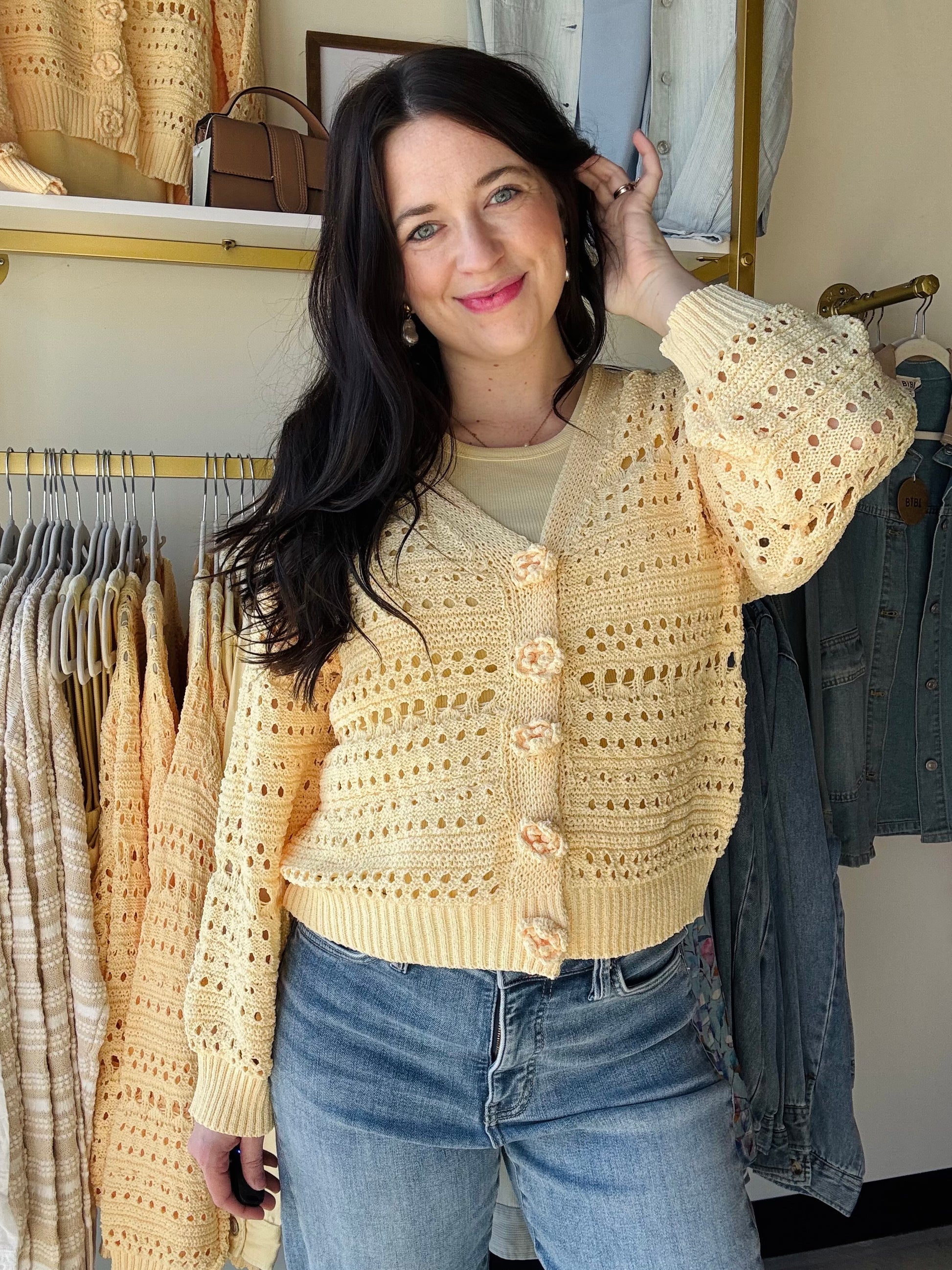 POL

A soft, open-knit sweater cardigan designed for effortless layering. It features uniquely handcrafted 3D floral buttons that serve as the key focal point. The silhouette is relaxed and easy without leaning too oversized, offering a comfortable and flattering fit.

--------------------------------------------------------------------------

Fabric Contents:

-&nbsp;100% POLYESTER

--------------------------------------------------------------------------

Specs/Dimensions:
- BUST: 22"
- LENGTH (Front and