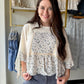 Pretty meets polished. The Dainty Floral Peplum Ribbed Top is the kind of top that does all the work for you — feminine floral detail, a figure-flattering peplum hem, and a cozy ribbed knit that hugs in all the right places.

Long sleeves make it a natural transition piece you can reach for well beyond summer, while the peplum silhouette adds just enough shape and movement to keep things interesting. Dress it up with tailored trousers or keep it casual with your go-to jeans — either way, it's an easy yes.
